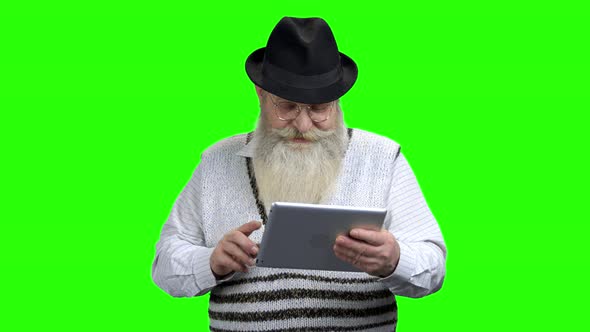 Smiling Senior Man Holding Computer Tablet