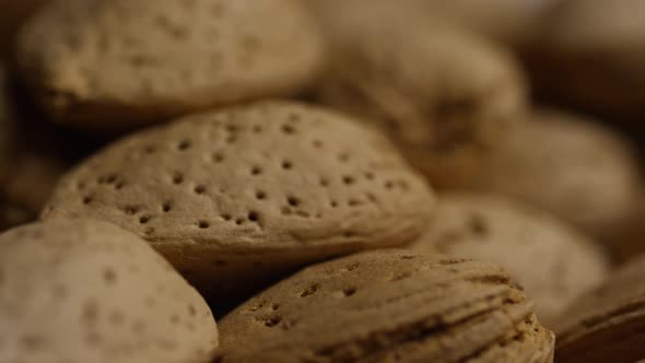 Cinematic, rotating shot of almonds on a white surface