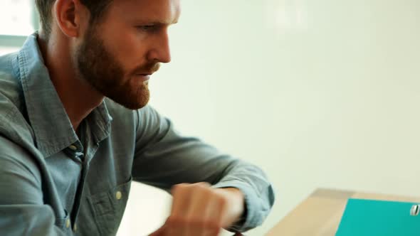 Male executive resting at his desk in office