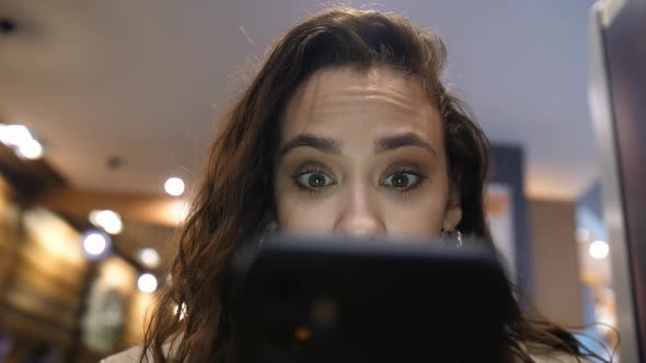 The Surprised Look of the Girl in the Smartphone