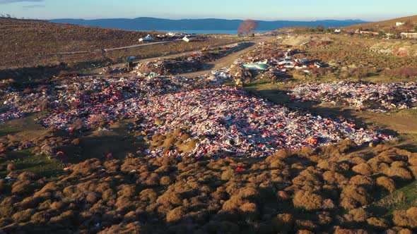 Piles of refugee life jackets ascending aerial Lesvos