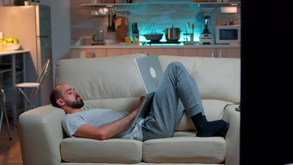 Exhausted Man Falling Asleep While Working on Internet Communication Project