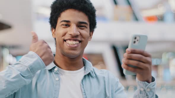 Portrait Satisfied Happy African Guy Man with Phone Smartphone Modern Gadget Looking at Camera Shows