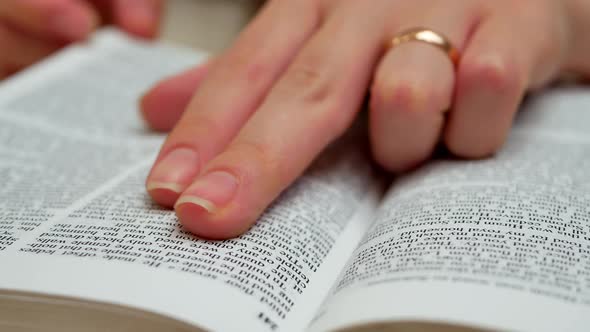 Woman's Hands Open The Book On Table And Find Information