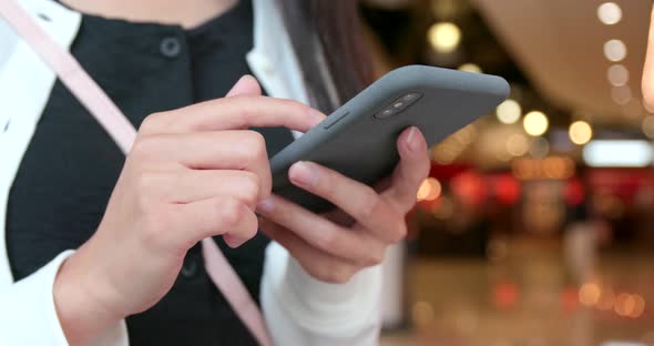 Woman use of mobile phone in shopping mall