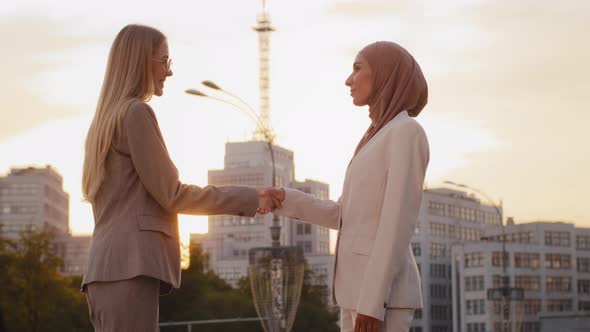 Smiling Young European Businesswoman Shaking Hand of Client at Meeting Friendly Realtor Broker