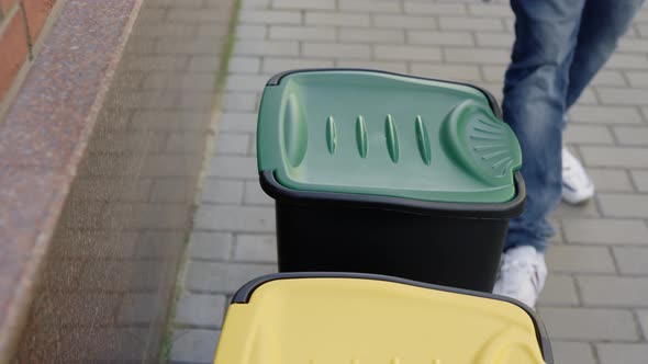 Close View of the Sorting Bin and the Male Hands in Gloves Puts Two Glass Bottles Inside the Glass