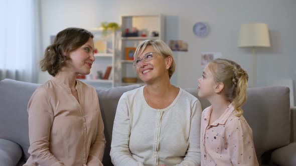 Young Female and Kid Kissing Grandmother Cheeks, Hugging Together, Family Love