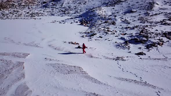 One Climber Is Walking Among the Snowy Mountains