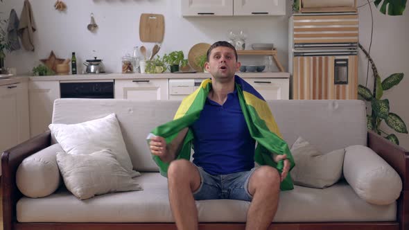 Brazilian Football Fan Man Watches TV and Rejoices in Victory