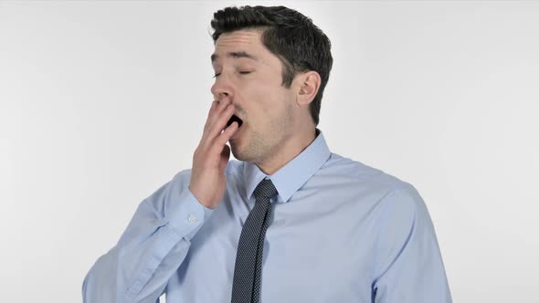 Tired Businessman Yawning on White Background