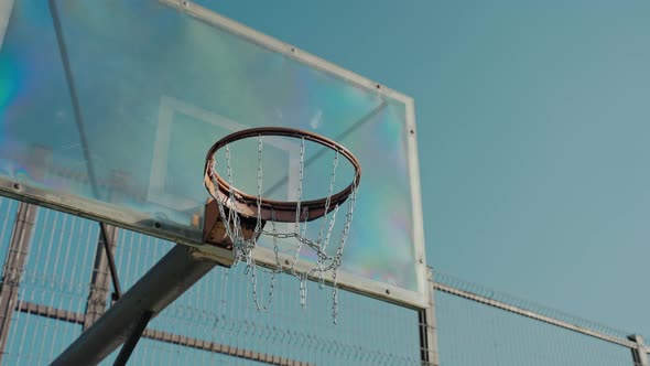 Basketball Basket on the Empty Court in the Park on a Sunny Autumn Day