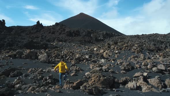Man Traveler Walks Through the Lava Field Around Chinyero Volcano in the Teide National Park on the