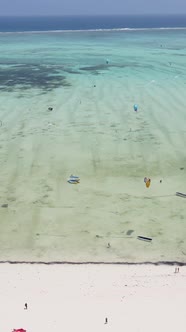 Vertical Video Kitesurfing Near the Shore of Zanzibar Tanzania