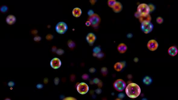 Blurred Footage of Beautiful Colorful Rainbow Soap Bubbles Flying in the Air Against a Black