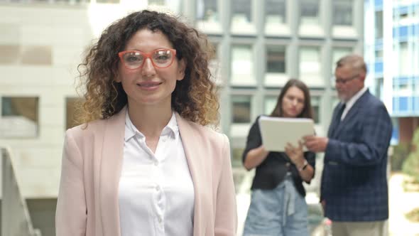 Portrait of a Middleaged Businesswoman in the Courtyard of a Large Business Center