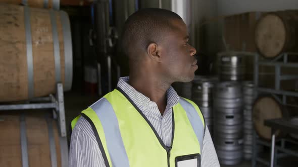 African American man smiling at camera and wearing high visibility vest