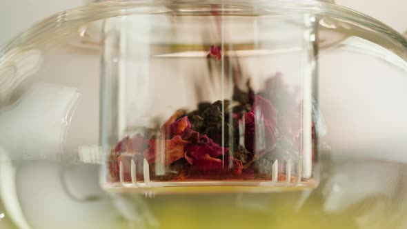 Putting Dry Tea Leaves Into Teapot Closeup