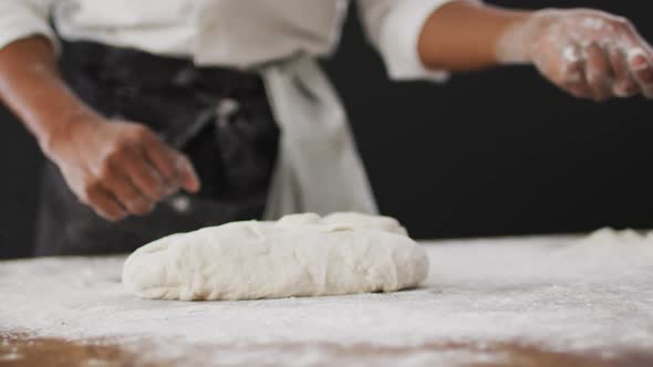 Video of cook throwing flour on the table on black background