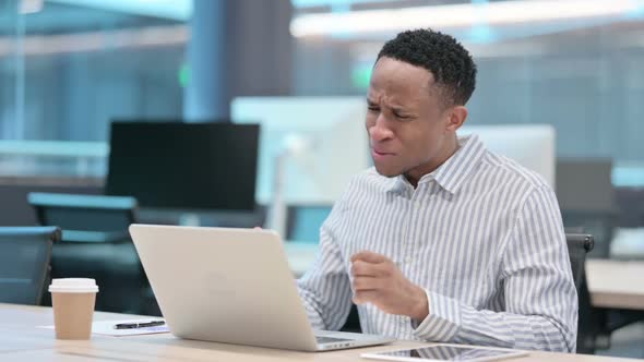 African Businessman with Laptop Having Loss Failure