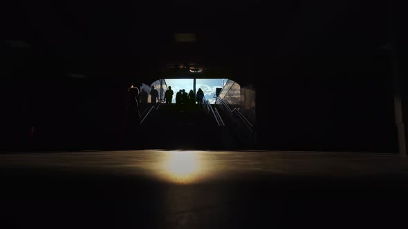 People Walk Through Dark Underpass Near Stairs at Susnet Underground Passage Metro