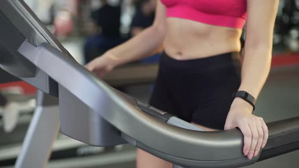 Sportive Lady With Flat Belly and Slim Body Starts Treadmill Exercising, Fitness