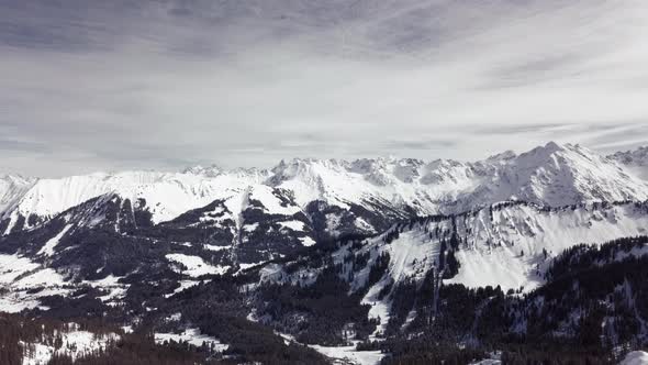 Aerial drone shot on montains in the alps, Austria, Kleinwalsertal, skiing area, snowy mountains