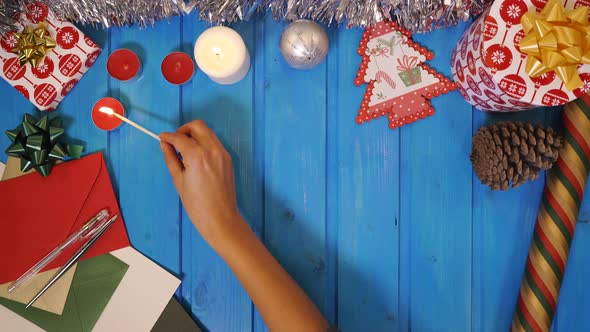 Woman hand lighting candles