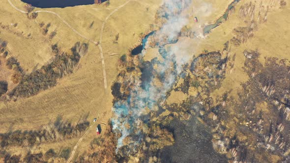 Aerial View. Spring Dry Grass Burns During Drought Hot Weather. Bush Fire And Smoke. Fire Engine