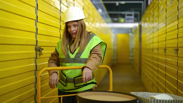 Medium Shot Confident Beautiful Woman Making Faces Grimacing Standing in Yellow Warehouse with