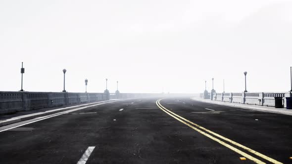 Illuminated Empty Road Bridge in a Fog