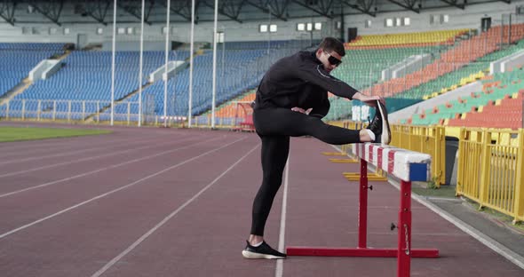 Young Athlete Warming Up Near Barrier