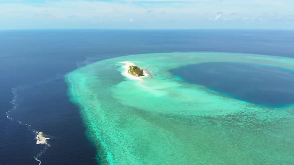 Aerial: Flying over idyllic atoll, scenic travel destination in Wakatobi Nationa