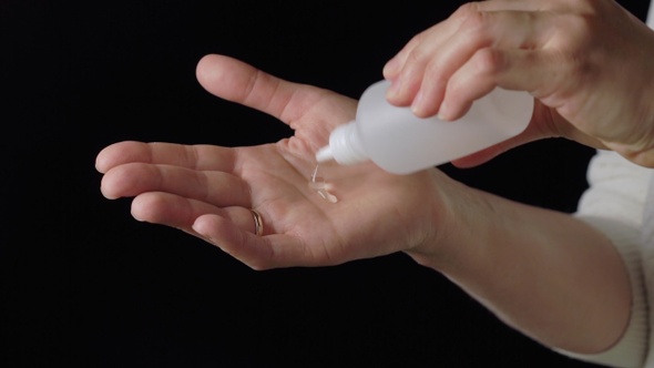 Young woman washing hands with alcohol sanitizer gel, daily protection for coronavirus COVID-19