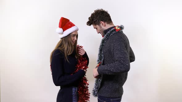 A young couple playing with tinsel