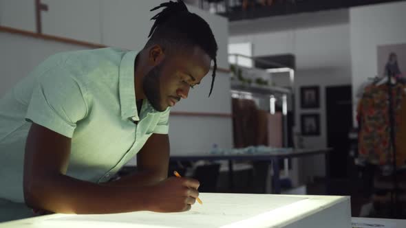 Mixed race man working in fashion office