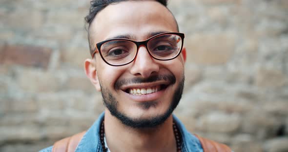 Close-up Slow Motion Portrait of Happy Middle Eastern Guy Smiling Outdoors