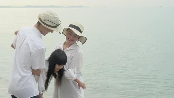 Happy asian family with father and mother relax carrying with daughter on vacation together.