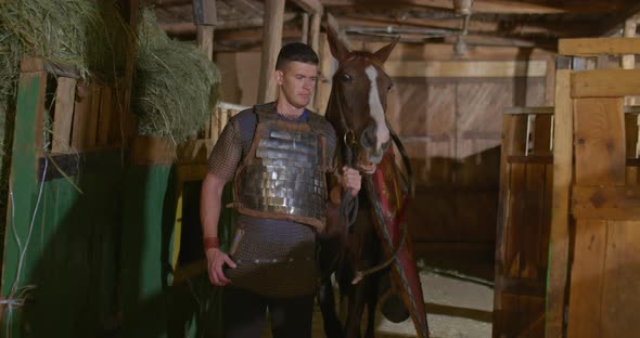 Portrait Warrior Armor Chain Mail Leads Horse Out Stable