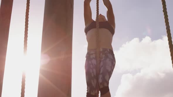 Young woman training at an outdoor gym bootcamp