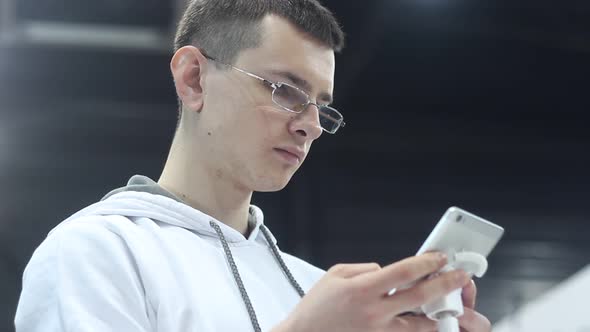 Young Man Uses A Smartphone