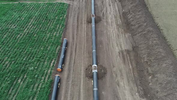 Aerial view of gas and oil pipeline construction. Pipes welded together.