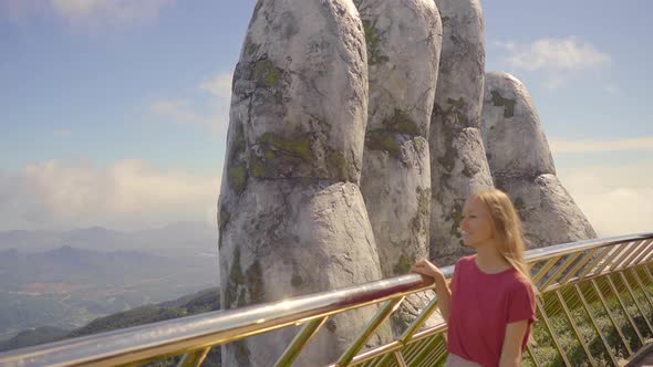 A Young Woman Traveler Visits the Golden Bridge in the Ba Na Hills in the City of Danang