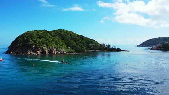 Wide angle drone travel shot of a white paradise beach and aqua turquoise water background in colorf