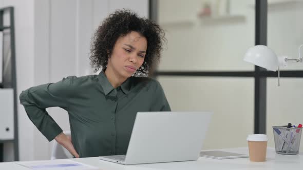 African Woman Having Back Pain While Using Laptop