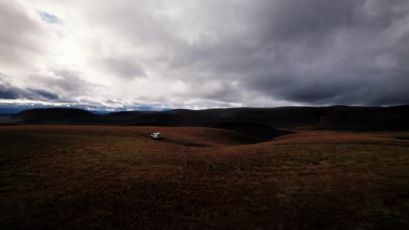 Drone Tracking Truck In Dark Mountain Landscape