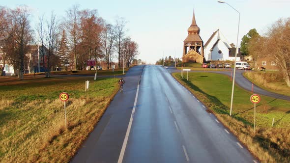 Man Skiing Down Lonely Rural Road Near Small Town Ostersund, Sweden. 4K Drone.