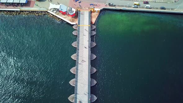 Tilt up aerial view of the Queen Emma Bridge in St. Anne's Bay towards the Otrobanda district in the