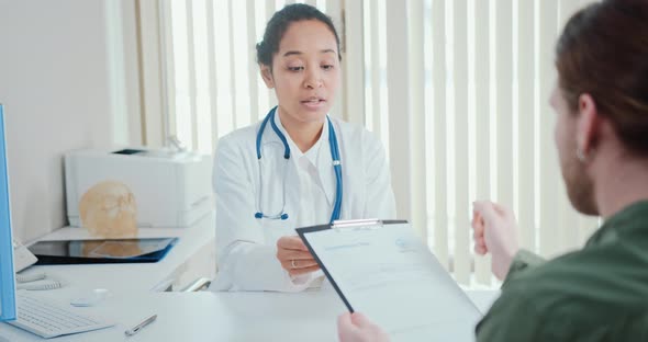 Doctor Video Footage - A Doctor Showing A Coronavirus Test Result