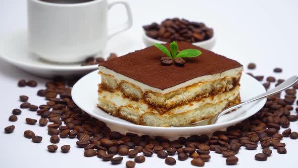 Traditional Tiramisu Dessert Square Portion and Cup of Fresh Espresso Coffee Isolated on White